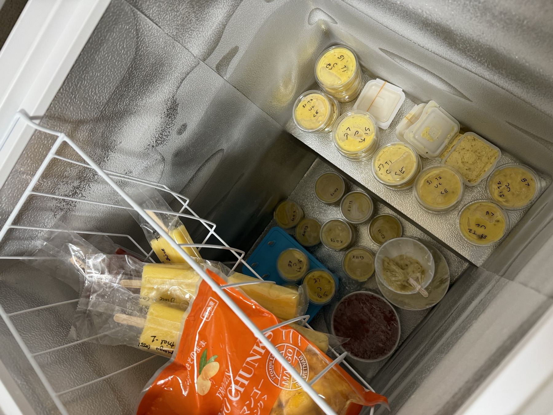 Labeled test batches of ice cream in a freezer